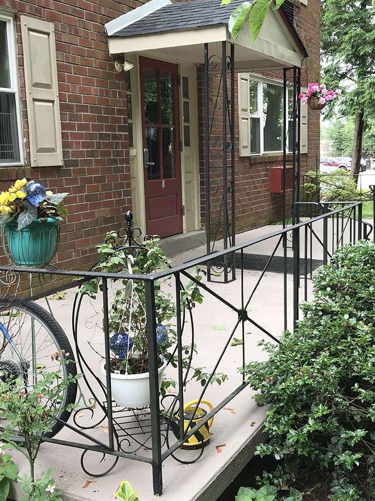 Entrance to a residential building with a porch and flowers at 韦斯特盖特的手臂 bbin出租